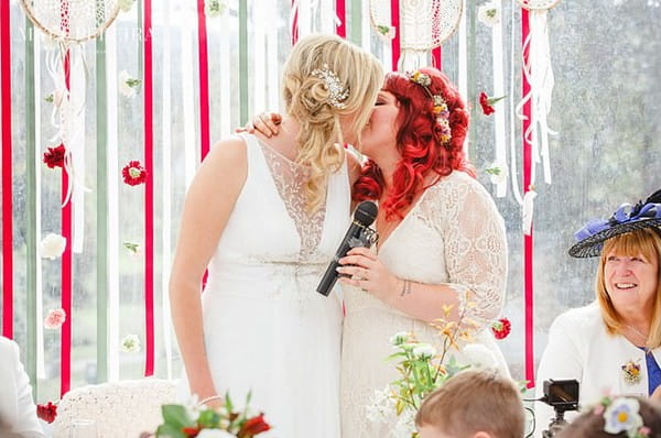 Brides kissing