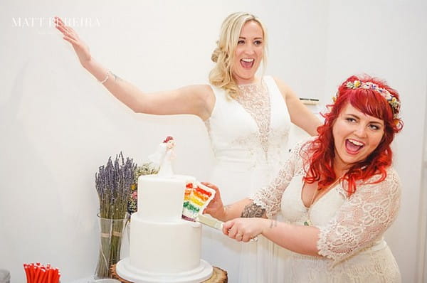 Bride's cutting rainbow wedding cake