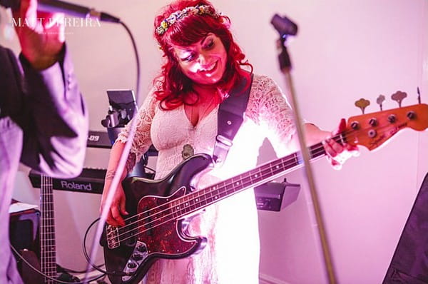 Bride playing bass guitar