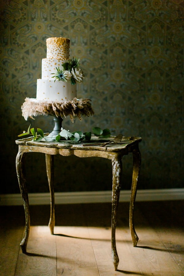 Wedding cake with feathers on table