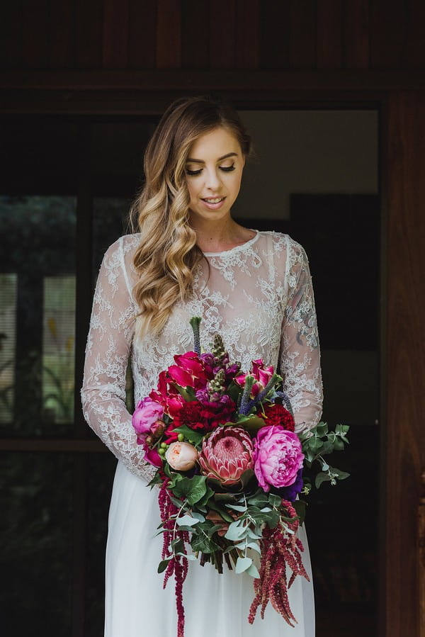 Bride in lace crop top holding bouquet