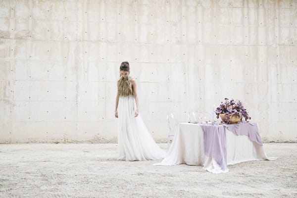 Bride standing by table