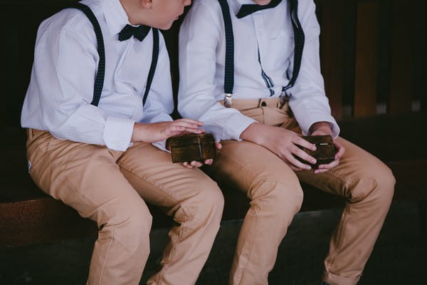 Pageboys holding ring boxes