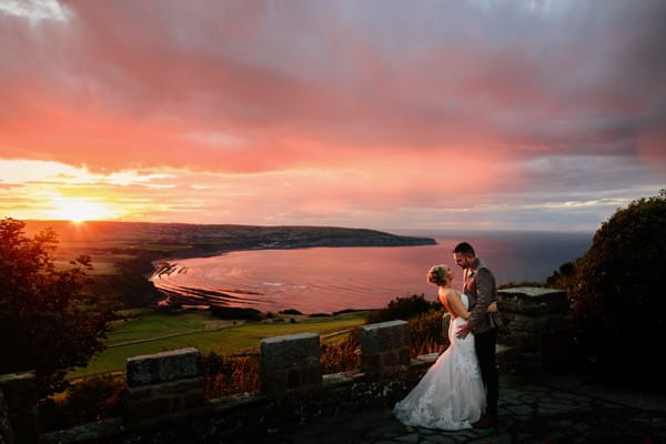 Bride and groom with pink sky of beautiful sunset - Picture by CJRodgers Photography