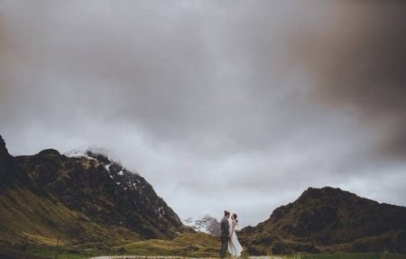 Bride and groom standing between two mountains - Picture by Steve Fuller Photography