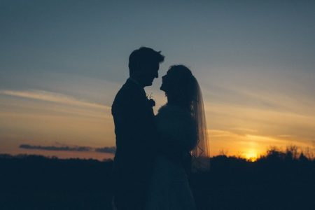 Silhouette of bride and groom as sun sets - Picture by Robin Ball Photography