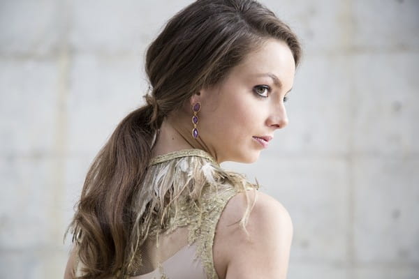 Bride with ponytail hairstyle and feather collar bridal neckpiece