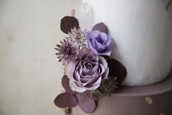 Purple flowers on wedding cake