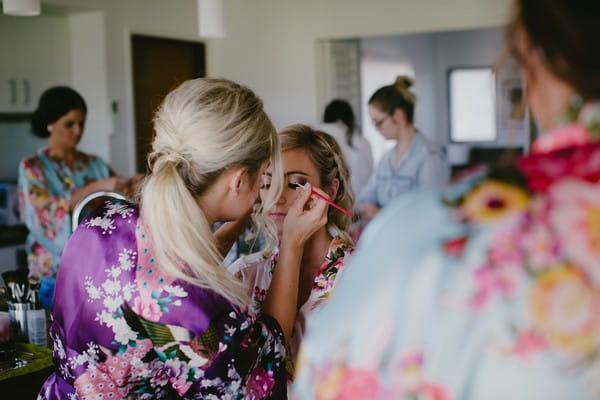 Bride having eye make-up applied