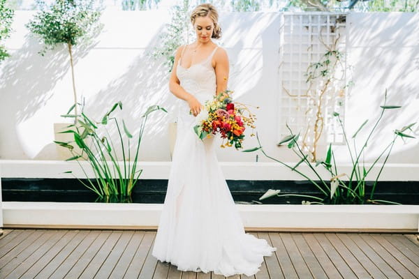 Bride holding bright and colourful wedding bouquet