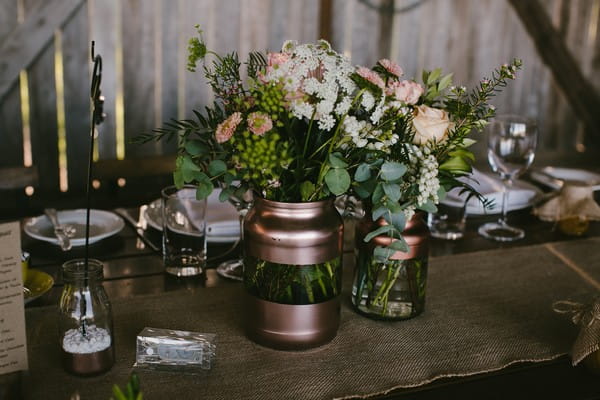 Glass and copper vases of flowers