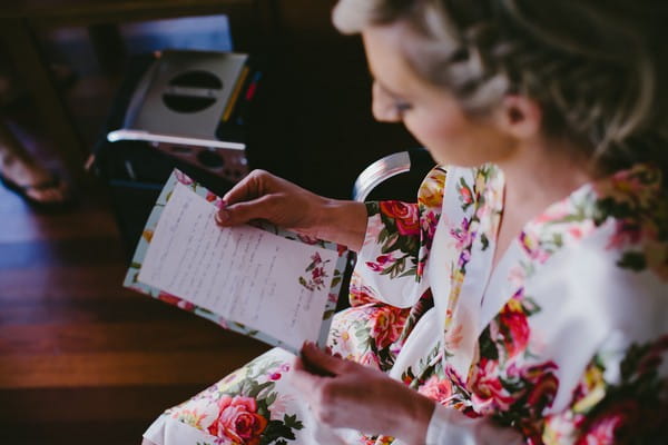 Bride reading letter before wedding