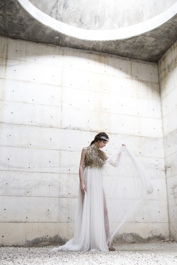 Bride pulling up train on dress