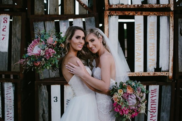 Two brides posing for picture