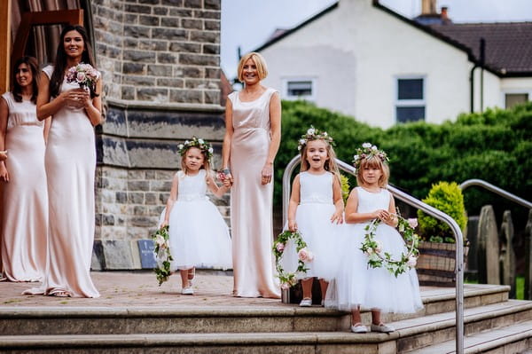 Bridesmaids and flower girls on steps of church