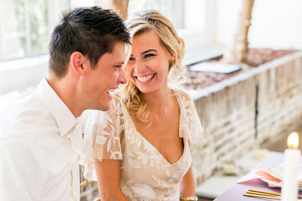 Bride and groom laughing together