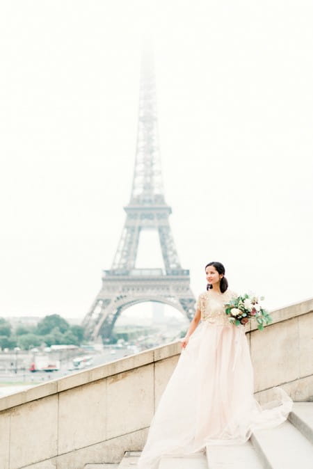 Bride holding bouquet with Eiffel Tower in background - Picture by Victoria JK Lamburn Photography