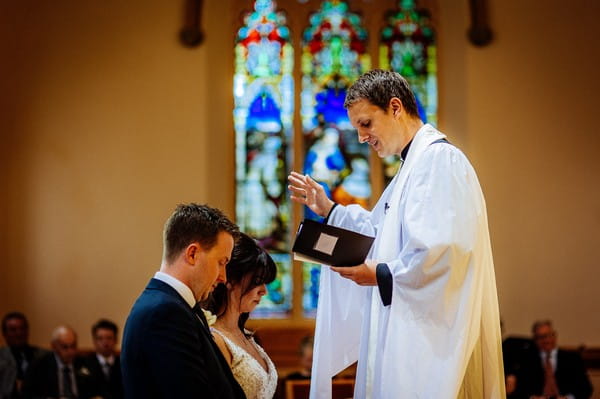 Vicar conducting wedding service