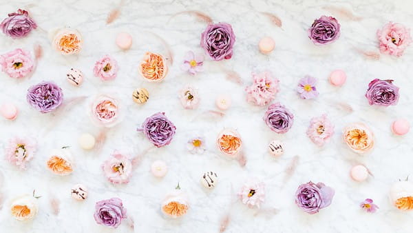 Violet and peach flowers with macarons