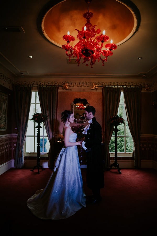 Bride and groom standing under light in Penventon Park Hotel