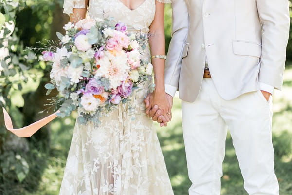 Bride and groom holding hands