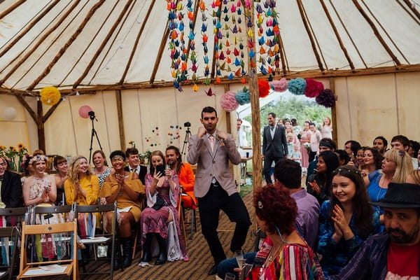 Groomsman dancing in to wedding ceremony