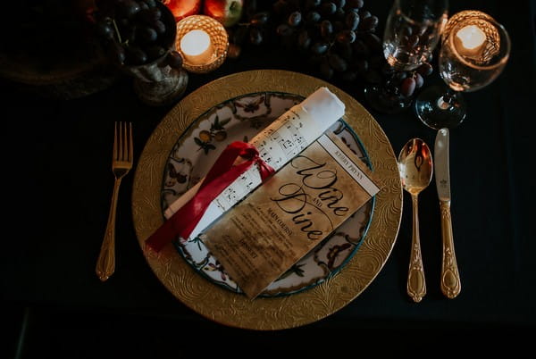 Wedding place setting with sheet music scroll and menu