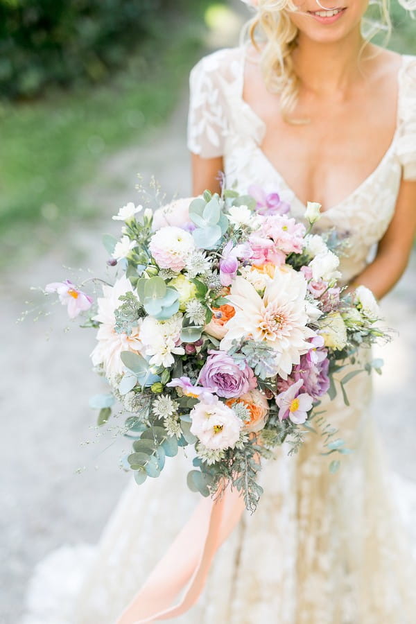 Bridal bouquet with violet, peach and white flowers