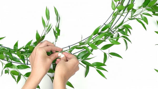 Attaching foliage to base of flower chandelier
