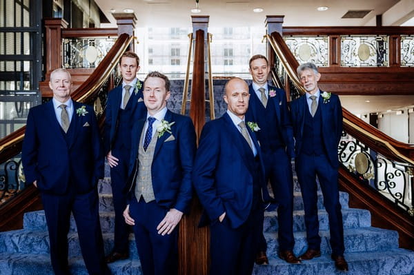 Groomsmen on stairs inside Titanic Hotel Liverpool