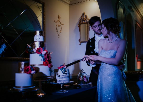 Bride and groom cutting wedding cake at Penventon Park Hotel
