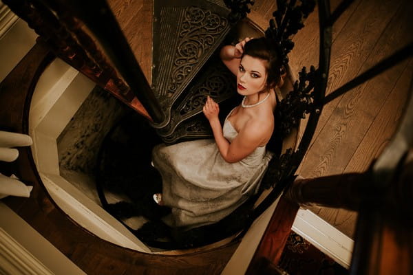 Bride on spiral staircase at Penventon Park Hotel