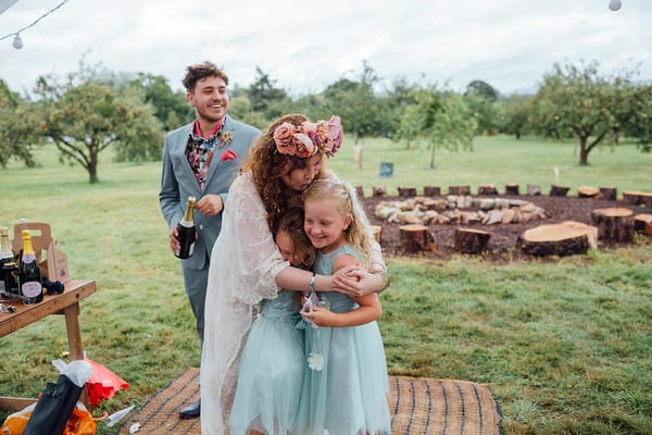 Bride hugging flower girls