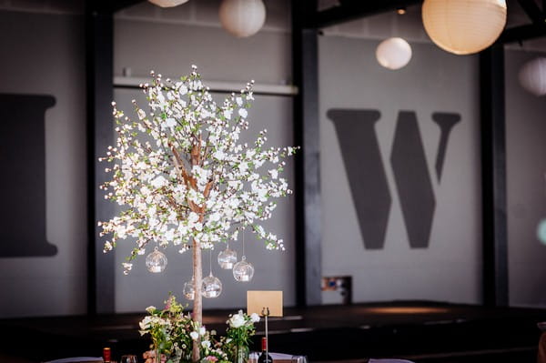 Tree with hanging tea lights on wedding table