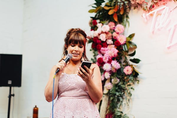 Bridesmaid reading speech on phone