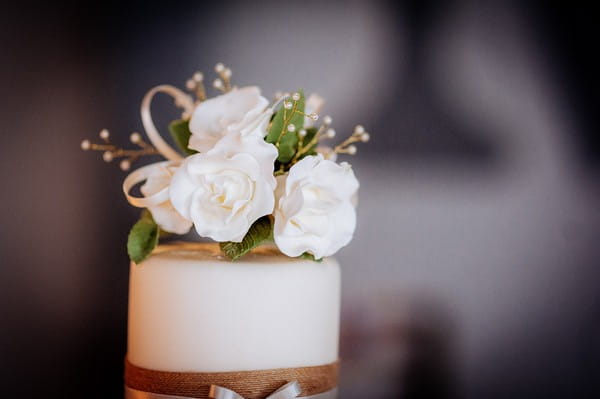 White flowers on top of wedding cake