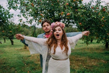 Bride and groom holding arms out