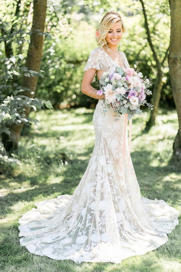 Bride with long wedding dress holding bouquet