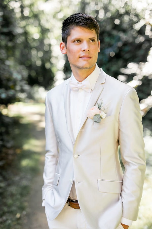 Groom wearing light grey suit