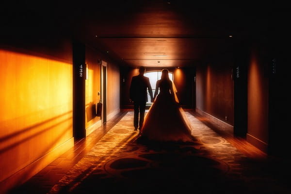 Bride and groom walking down corridor of the Titanic Hotel Liverpool