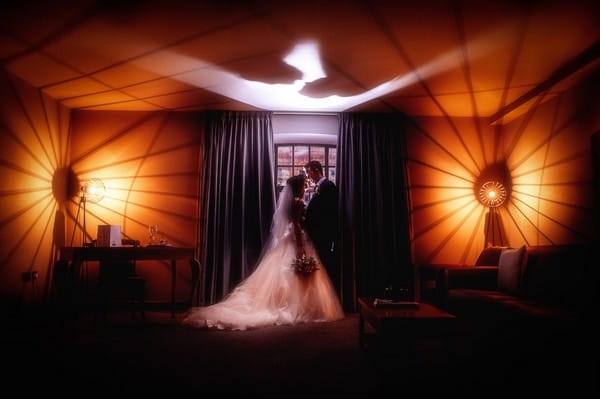 Bride and groom standing in front of window inside the Titanic Hotel Liverpool