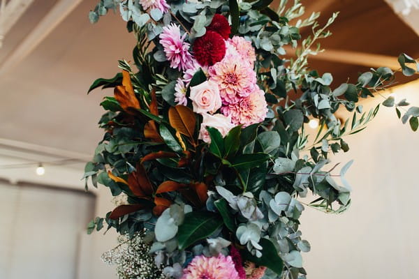 Wedding flowers and foliage on pillar