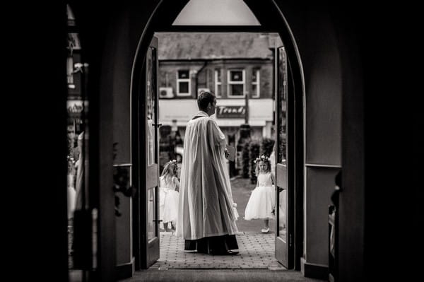 Vicar waiting for bride outside church