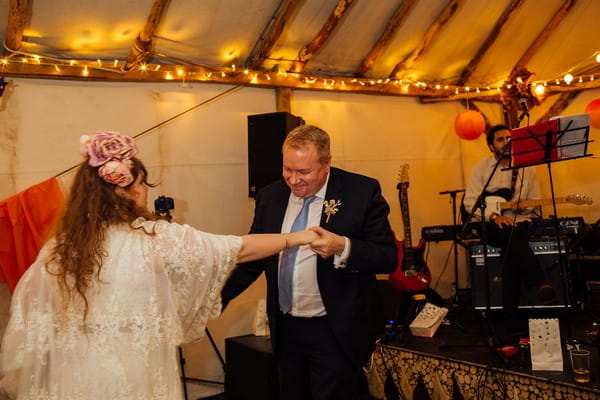 Bride dancing with man