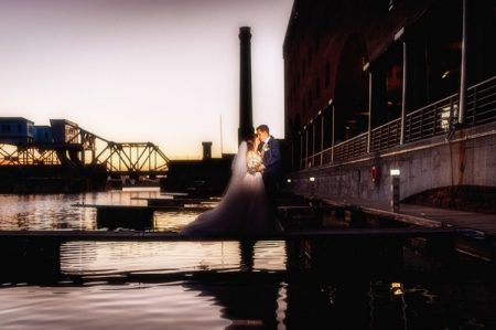 Bride and groom kissing at Liverpool Dock