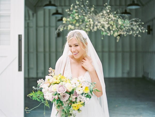 Bride with veil holding bouquet