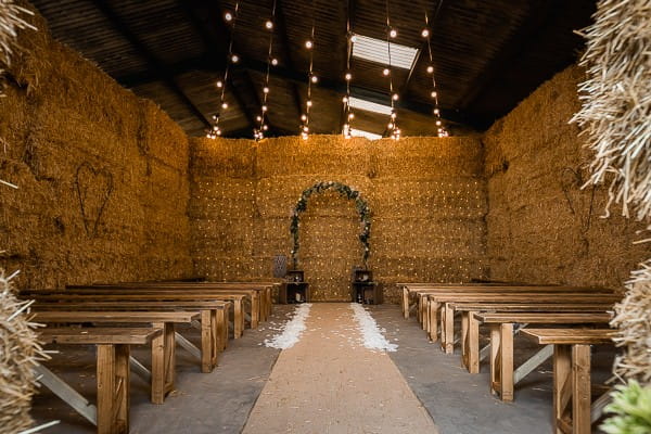 Wedding ceremony seating in cow shed