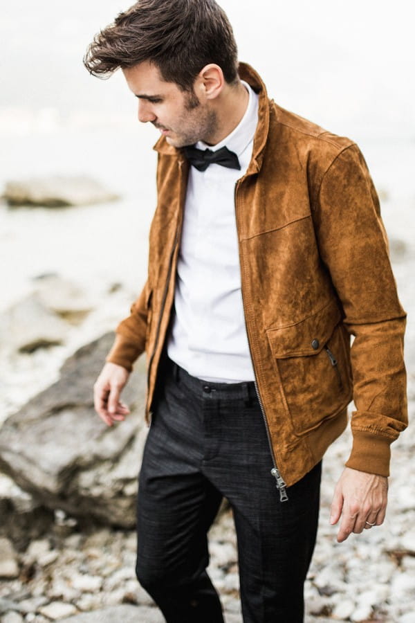 Groom wearing tan suede jacket