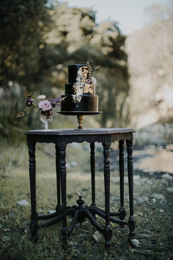 Black wedding cake on table