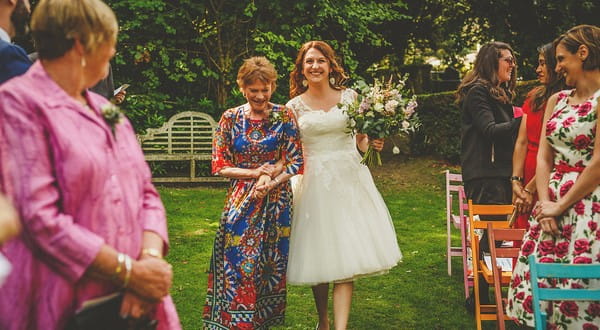 Mother walking bride down the aisle